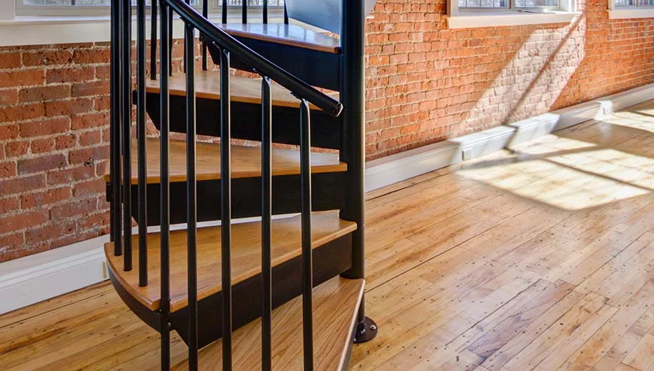 residential condo steel spiral stair with wood accents