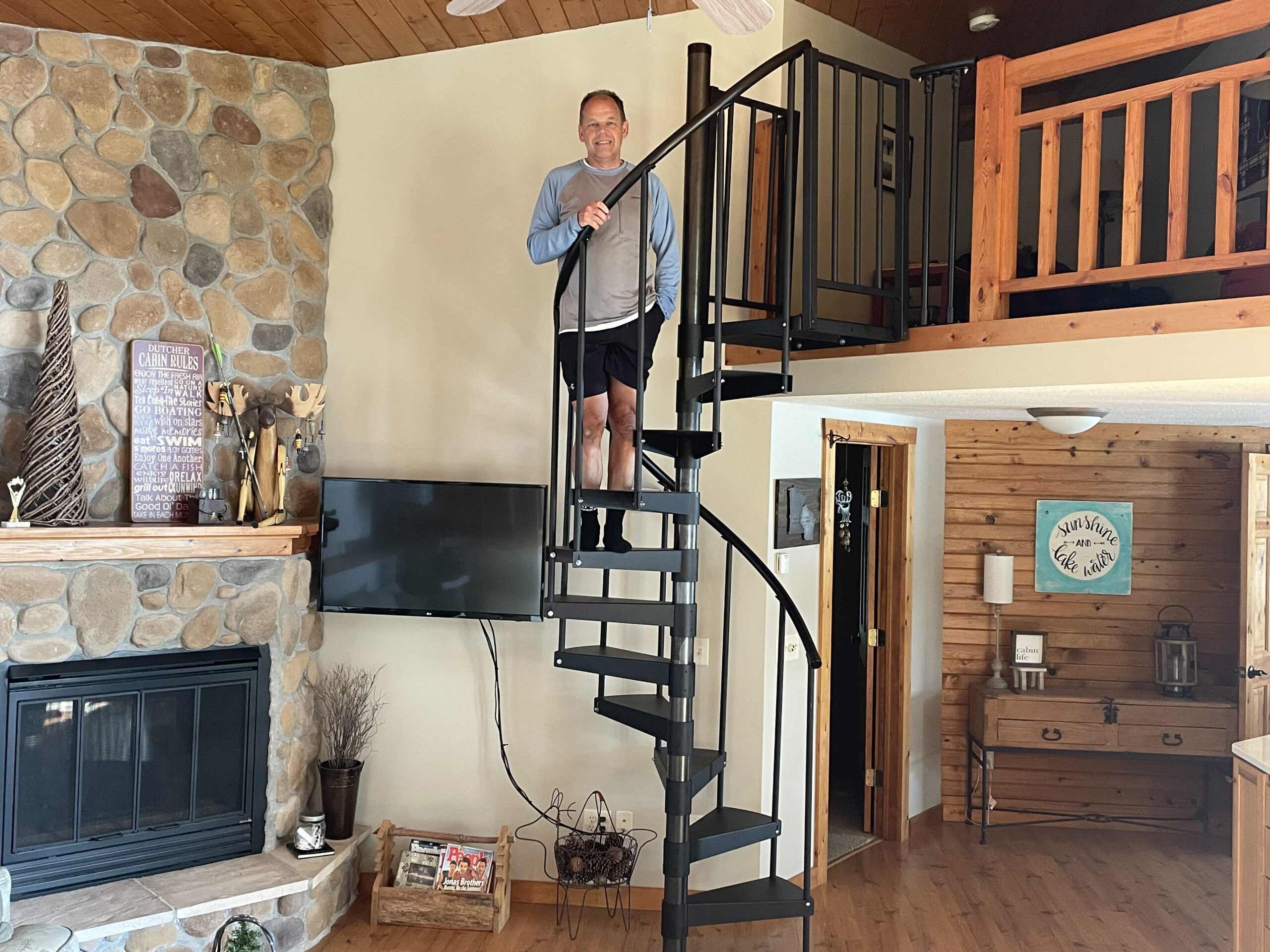 client standing on indoor spiral staircase