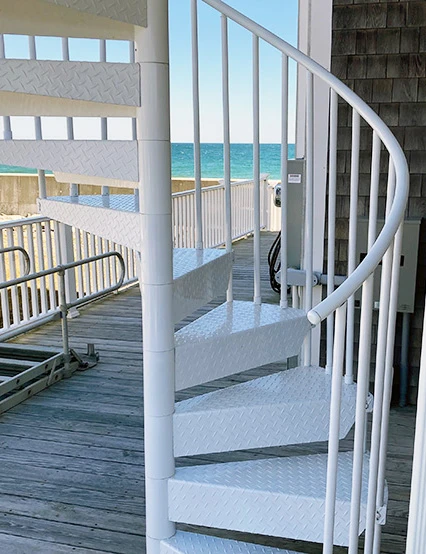 beach front property with white outdoor spiral staircase