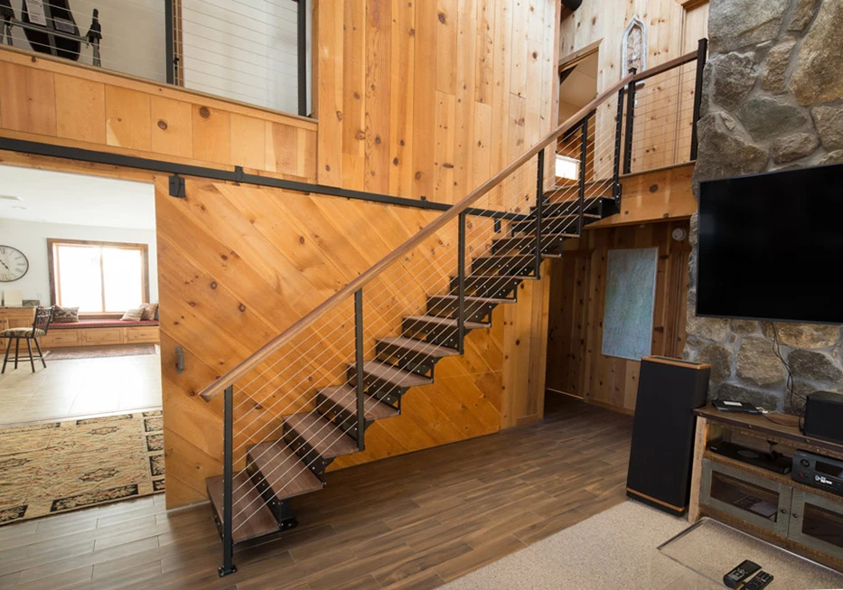 modular floating stair kit in rustic home with wood paneling