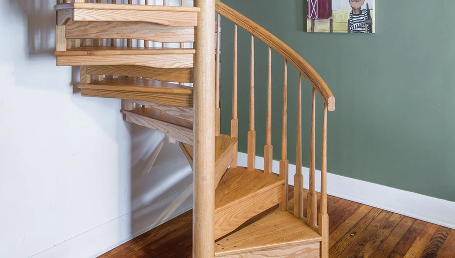 stained solid wood spiral staircase in residential home
