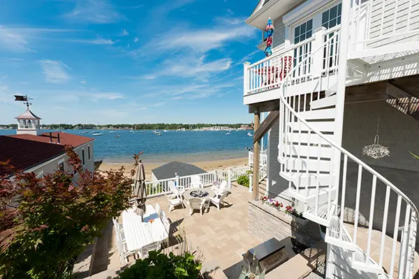 Outdoor spiral deck stairs fitting a tight deck layout and providing access without blocking patio or waterfront views